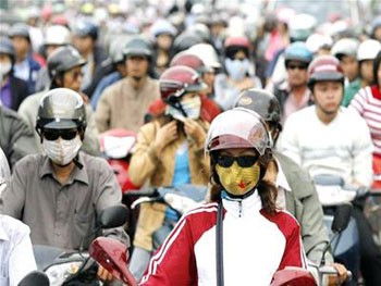 Motorcyclists wear masks to protect themselves from polluted air Motorcyclists wear masks to protect themselves from polluted air