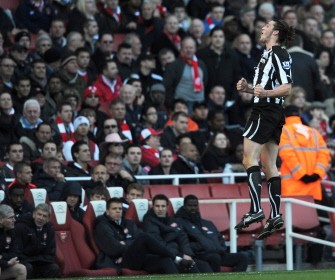 Newcastle United's forward Andy Carroll (R) jumps to celebrate scoring the opening goal in front of the Arsenal Manager Arsene Wenger (2nd L) during the Premiership football match at the Emirates Stadium in London on November 7, 2010. AFP Newcastle United's forward Andy Carroll (R) jumps to celebrate scoring the opening goal in front of the Arsenal Manager Arsene Wenger (2nd L) during the Premiership football match at the Emirates Stadium in London on November 7, 2010. AFP