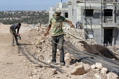 Palestinian labourers work in October 2010 at the construction site for 50 housing units in the West Bank settlement of Ariel Palestinian labourers work in October 2010 at the construction site for 50 housing units in the West Bank settlement of Ariel