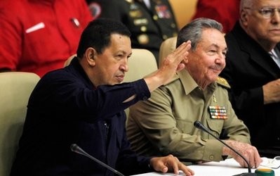 Venezuela's President Hugo Chavez, left, waves to the crowd next to Cuba's President Raul Castro during a meeting in Havana, Cuba, Monday Nov. 8, 2010. Venezuela's President Hugo Chavez, left, waves to the crowd next to Cuba's President Raul Castro during a meeting in Havana, Cuba, Monday Nov. 8, 2010.