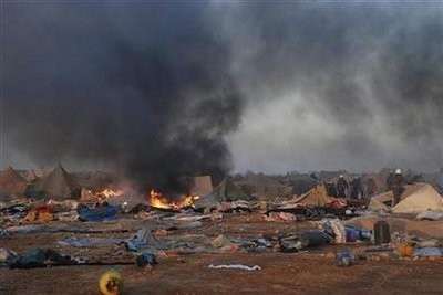 Tent burns after Moroccan security forces broke up the tent camp on the outskirts of Western Sahara's capital, Laayoune November 8, 2010. Tent burns after Moroccan security forces broke up the tent camp on the outskirts of Western Sahara's capital, Laayoune November 8, 2010.