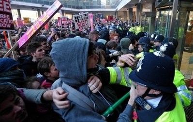 Demonstrators clash with police as they try to gain entry to 30 Millbank, the headquarters of Britain's Conservative Party, during a student protest march, in central London on November 10. AFP Demonstrators clash with police as they try to gain entry to 30 Millbank, the headquarters of Britain's Conservative Party, during a student protest march, in central London on November 10. AFP