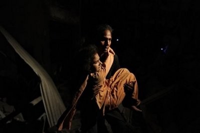 A Pakistani volunteer rescues a woman from the debris of a collapsed building following a bomb blast in Karachi on November 11, 2010 A Pakistani volunteer rescues a woman from the debris of a collapsed building following a bomb blast in Karachi on November 11, 2010