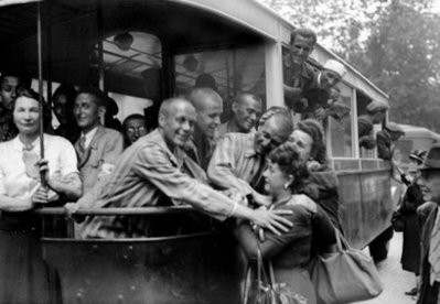 A group of deportees still wearing their concentration camp uniforms are greeted by locals on their arrival back in Paris in 1945 after being liberated by Allied forces in Germany. A group of deportees still wearing their concentration camp uniforms are greeted by locals on their arrival back in Paris in 1945 after being liberated by Allied forces in Germany.