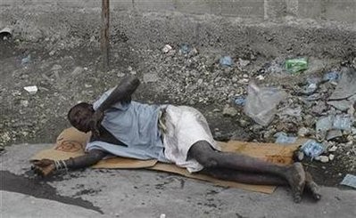A Haitian resident suffering from cholera waits for help on a street at the slum of Cite-Soleil in Port-au-Prince November 10, 2010 A Haitian resident suffering from cholera waits for help on a street at the slum of Cite-Soleil in Port-au-Prince November 10, 2010