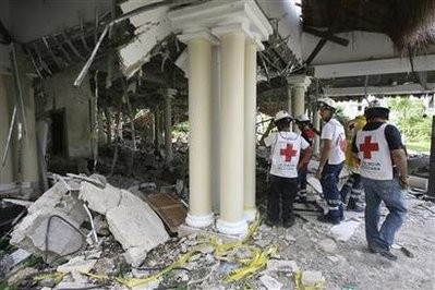 Members of the Red Cross stand near a destroyed area after an explosion at a hotel in Cancun November 14, 2010 Members of the Red Cross stand near a destroyed area after an explosion at a hotel in Cancun November 14, 2010