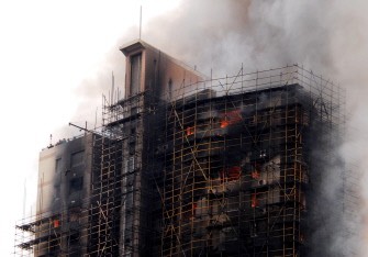 This photo taken on November 15, 2010 shows a huge fire engulfing a high-rise in Shanghai. AFP This photo taken on November 15, 2010 shows a huge fire engulfing a high-rise in Shanghai. AFP