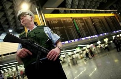 A police officer patrols inside the main terminal of Frankfurt's airport, November 17, 2010 A police officer patrols inside the main terminal of Frankfurt's airport, November 17, 2010