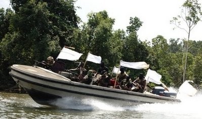 File photo shows Nigerian rebels brandishing their weapons while on patrol on a river in the Niger Delta region. File photo shows Nigerian rebels brandishing their weapons while on patrol on a river in the Niger Delta region.