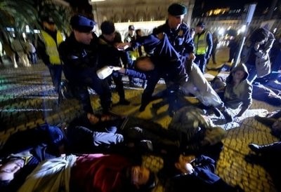 Policemen move some activists during a protest against NATO in downtown Lisbon, on November 18, 2010. AFP Policemen move some activists during a protest against NATO in downtown Lisbon, on November 18, 2010. AFP
