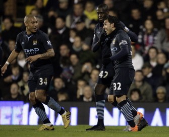 Manchester City's Carlos Tevez (R) celebrates after scoring his second goal against Fulham with teammates Ivory Coast player Yaya Toure (C) and Dutch player Nigel de Jong. AFP Manchester City's Carlos Tevez (R) celebrates after scoring his second goal against Fulham with teammates Ivory Coast player Yaya Toure (C) and Dutch player Nigel de Jong. AFP