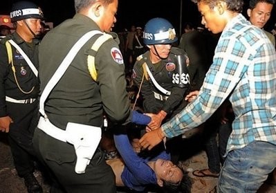 Cambodian military police carry a body near a bridge in Phnom Penh. AFP Cambodian military police carry a body near a bridge in Phnom Penh. AFP