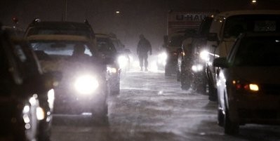 U.S. Army Spc. Ron Washington walks from his Humvee and past stuck cars on the Alaskan Way Viaduct to check on the gridlock on the highway Monday, Nov. 22, 2010, U.S. Army Spc. Ron Washington walks from his Humvee and past stuck cars on the Alaskan Way Viaduct to check on the gridlock on the highway Monday, Nov. 22, 2010,
