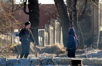 An armed North Korean soldier (L) and civilian talk on the banks of of the North Korean border town of Siniuju across the Yalu River from Dandong in northeast China's Liaoning province on November 25, 2010. AFP An armed North Korean soldier (L) and civilian talk on the banks of of the North Korean border town of Siniuju across the Yalu River from Dandong in northeast China's Liaoning province on November 25, 2010. AFP