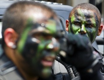 Riot policemen get ready to enter Vila Cruzeiro shantytown on an armoured personnel carrier on November 25, 2010 in Rio de Janeiro, Brazil. AFP Riot policemen get ready to enter Vila Cruzeiro shantytown on an armoured personnel carrier on November 25, 2010 in Rio de Janeiro, Brazil. AFP