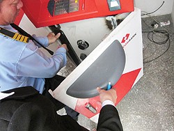 An official checks the ATM safe box, which the thieves are supposed to use welding machine to open (Photo: Thanh Nien) An official checks the ATM safe box, which the thieves are supposed to use welding machine to open (Photo: Thanh Nien)