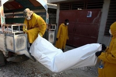 Health workers at a tent city on the outskirts of Port-au-Prince remove the body of a cholera victim. Health workers at a tent city on the outskirts of Port-au-Prince remove the body of a cholera victim.