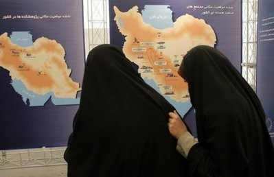 Iranian students walk past maps during an exhibition of nuclear industry achievements at the Shahid Beheshti University, north of Tehran. Iranian students walk past maps during an exhibition of nuclear industry achievements at the Shahid Beheshti University, north of Tehran.