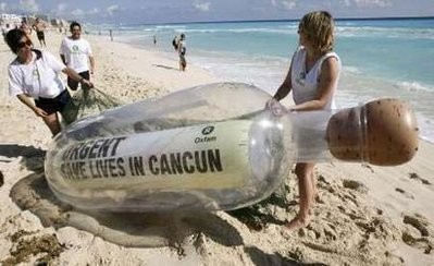 Activists of Oxfam carry a giant bottle on the shores of a beach in Cancun November 28, 2010. The bottle contains a message reading Urgent: "Save Lives in Cancun", in reference to millions of world's poorest people. Activists of Oxfam carry a giant bottle on the shores of a beach in Cancun November 28, 2010. The bottle contains a message reading Urgent: "Save Lives in Cancun", in reference to millions of world's poorest people.