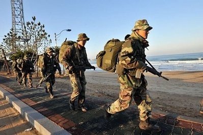 South Korean Marines march on a coastal road after a landing operation was cancelled due to bad weather, at Mallipo beach in Taean, about 170 kms southwest of Seoul. South Korean Marines march on a coastal road after a landing operation was cancelled due to bad weather, at Mallipo beach in Taean, about 170 kms southwest of Seoul.