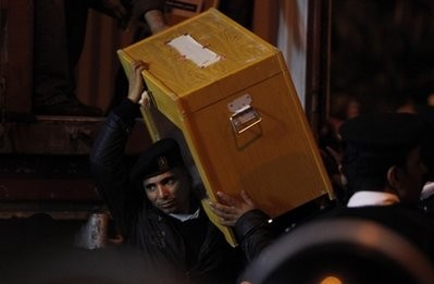 A Police officer carries a ballot box to a counting center, after polls closed in Alexandria, Egypt, Sunday, Nov. 28, 2010. A Police officer carries a ballot box to a counting center, after polls closed in Alexandria, Egypt, Sunday, Nov. 28, 2010.