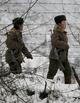 North Korean soldiers patrol on a pathway along the bank of the Yalu River, the China-North Korea border river, near North Korea's town of Sinuiju, opposite side of the Chinese border city of Dandong, Sunday Nov. 28, 2010. North Korean soldiers patrol on a pathway along the bank of the Yalu River, the China-North Korea border river, near North Korea's town of Sinuiju, opposite side of the Chinese border city of Dandong, Sunday Nov. 28, 2010.
