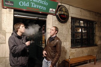 Two men smoke cigarettes outside a bar in Burgos on January 2, 2011 following the introduction of the new law. AFP Two men smoke cigarettes outside a bar in Burgos on January 2, 2011 following the introduction of the new law. AFP