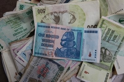 An old one hundred trillion Zimbabwean dollar note on top of a pile of other old Zimbabwean notes of various denominations in Harare, Thursday, Dec. 30, 2010 An old one hundred trillion Zimbabwean dollar note on top of a pile of other old Zimbabwean notes of various denominations in Harare, Thursday, Dec. 30, 2010