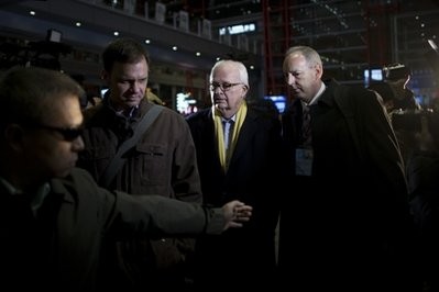 A body guard, left, tries to shield off journalists while U.S. special envoy for North Korea Stephen Bosworth, second right, walks out of an exit upon arrival at the Capital Airport in Beijing, China, Wednesday, Jan. 5, 2011. A body guard, left, tries to shield off journalists while U.S. special envoy for North Korea Stephen Bosworth, second right, walks out of an exit upon arrival at the Capital Airport in Beijing, China, Wednesday, Jan. 5, 2011.