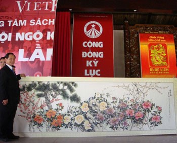 Painter Truong Han Minh and his giant watercolor painting. Painter Truong Han Minh and his giant watercolor painting.