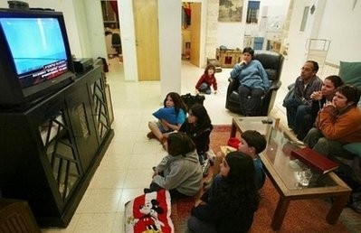 A family watching TV. People who spend more than two hours per day of leisure time watching television or sitting in front of a screen face double the risk of heart disease and higher risk of dying, a new study has shown A family watching TV. People who spend more than two hours per day of leisure time watching television or sitting in front of a screen face double the risk of heart disease and higher risk of dying, a new study has shown