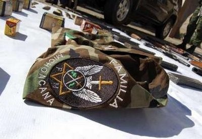 Fatigues with an embroidered logo of the La Familia drug cartel is presented to the media along with weaponry, drugs and cars confiscated in an operation in Morelia January 10, 2011 Fatigues with an embroidered logo of the La Familia drug cartel is presented to the media along with weaponry, drugs and cars confiscated in an operation in Morelia January 10, 2011