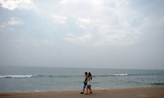 A couple walks on the beach in Colombo on January 10, 2011. AFP A couple walks on the beach in Colombo on January 10, 2011. AFP