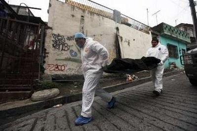 A forensic team carries the body of one of three gunmen killed during a gunfight with the army in Monterrey January 13, 2011. A forensic team carries the body of one of three gunmen killed during a gunfight with the army in Monterrey January 13, 2011.