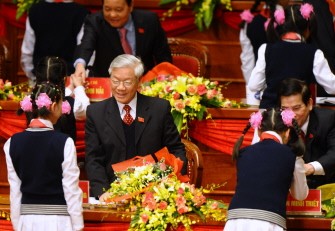 Young pioneer girls and boys salute politiburo member and National Assembly Chairman Nguyen Phu Trong (C), politburo member and President Nguyen Minh Triet (R) and others leaders on podium during the opening of the 11th national congress of the Vietnam Communist Party (VCP) in Hanoi on January 12, 2011. Young pioneer girls and boys salute politiburo member and National Assembly Chairman Nguyen Phu Trong (C), politburo member and President Nguyen Minh Triet (R) and others leaders on podium during the opening of the 11th national congress of the Vietnam Communist Party (VCP) in Hanoi on January 12, 2011.