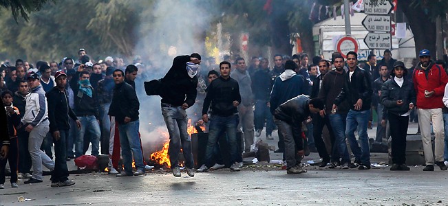 Demonstrators throw rocks towards police during clashes in Tunis Demonstrators throw rocks towards police during clashes in Tunis