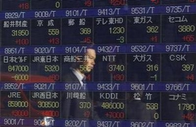 A man is reflected in an electronic board displaying share prices outside a brokerage in Tokyo January 6, 2011 A man is reflected in an electronic board displaying share prices outside a brokerage in Tokyo January 6, 2011