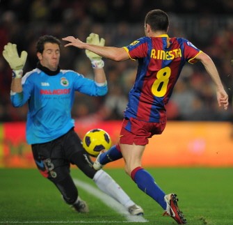 Barcelona's midfielder Andres Iniesta (R) vies with Racing Santander's goalkeeper Tono (L) on January 22, 2011. AFP Barcelona's midfielder Andres Iniesta (R) vies with Racing Santander's goalkeeper Tono (L) on January 22, 2011. AFP