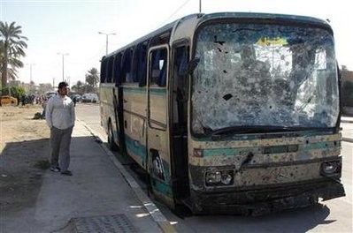 A resident looks at a damaged bus after a bomb attack in Baghdad's Kadhimiya district January 23, 2011 A resident looks at a damaged bus after a bomb attack in Baghdad's Kadhimiya district January 23, 2011
