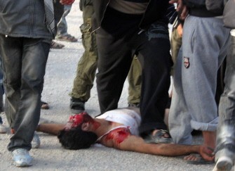 A bloodied protestor lies on the road after allegedly being fatally shot during clashes with anti-riot police in Sheikh Zuweid in the Sinai, some 344 km northeast of Cairo, on January 27, 2011. AFP A bloodied protestor lies on the road after allegedly being fatally shot during clashes with anti-riot police in Sheikh Zuweid in the Sinai, some 344 km northeast of Cairo, on January 27, 2011. AFP