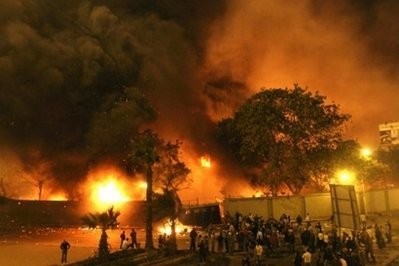 AFP - Egyptians gather around the burning headquarters of the ruling National Democratic party (NDP) in central Cairo. AFP - Egyptians gather around the burning headquarters of the ruling National Democratic party (NDP) in central Cairo.