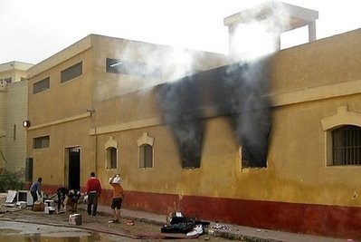 AFP - Looters walk away with goods as smoke billows from the riot-hit Abu Zaabel prison in the Egyptian capital Cairo AFP - Looters walk away with goods as smoke billows from the riot-hit Abu Zaabel prison in the Egyptian capital Cairo