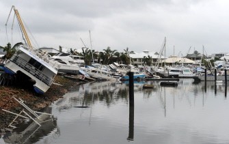 Damaged boats rest against luxury waterfront homes in Cardwell on February 4, 2011. Damaged boats rest against luxury waterfront homes in Cardwell on February 4, 2011.