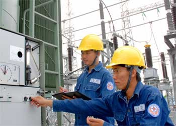 Electricians check a power panel in Ho Chi Minh City Electricians check a power panel in Ho Chi Minh City