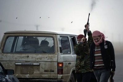 A Libyan rebel fighter fires his rifle in the air at Ajdabiya's west gate. AFP A Libyan rebel fighter fires his rifle in the air at Ajdabiya's west gate. AFP