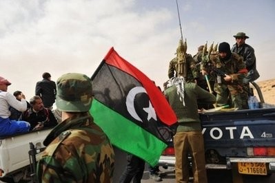 Libyan rebel fighters check their equipment at Ras Lanuf before advancing into the north central town of Benjawad. Libyan rebel fighters check their equipment at Ras Lanuf before advancing into the north central town of Benjawad.