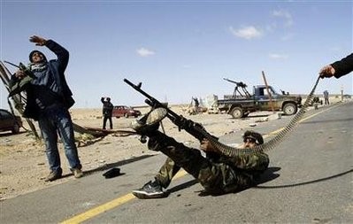 A rebel fighter fires his rifle at a military aircraft loyal to Libyan leader Muammar Gaddafi at a checkpoint in Ras Lanuf March 7, 2011 A rebel fighter fires his rifle at a military aircraft loyal to Libyan leader Muammar Gaddafi at a checkpoint in Ras Lanuf March 7, 2011