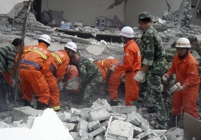 Rescue workers look for survivors in a collapsed building after an earthquake jolted Yingjiang county in southwestern China's Yunnan Province on Thursday, March 10, 2011 Rescue workers look for survivors in a collapsed building after an earthquake jolted Yingjiang county in southwestern China's Yunnan Province on Thursday, March 10, 2011