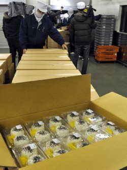 food factory employee packs rice-balls into the boxes as relief for quake survivors in Akita city on March 15, 2011. (Photo: AFP) food factory employee packs rice-balls into the boxes as relief for quake survivors in Akita city on March 15, 2011. (Photo: AFP)