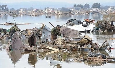 Japanese soldiers search through flooded lowland areas in Natori, Miyagi prefecture Japanese soldiers search through flooded lowland areas in Natori, Miyagi prefecture